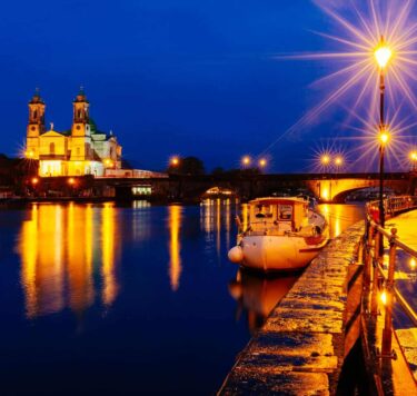 Athlone at Night Time by the River Shannon, with a boat in frame