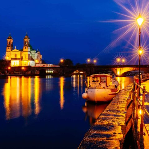 Athlone at Night Time by the River Shannon, with a boat in frame