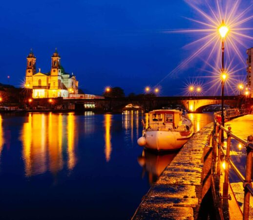 Athlone at Night Time by the River Shannon, with a boat in frame