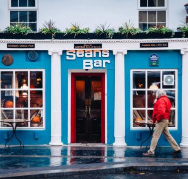 Exterior of Seans Bar with man walking in front