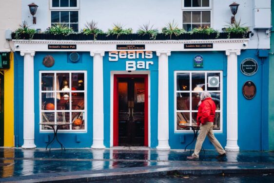 Exterior of Seans Bar with man walking in front