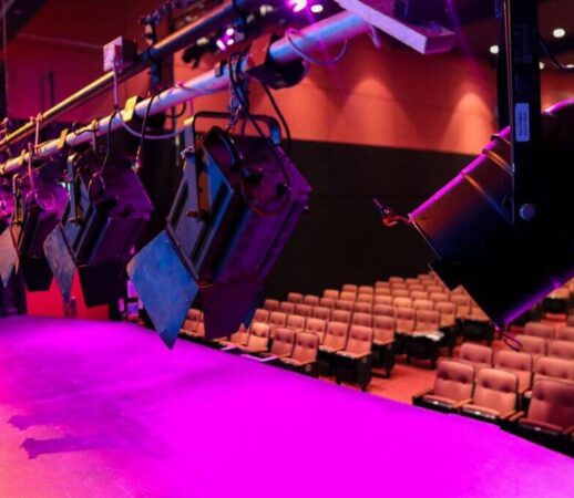 Modern theatre stage with vibrant lighting and plush seating at Dean Crowe Theatre